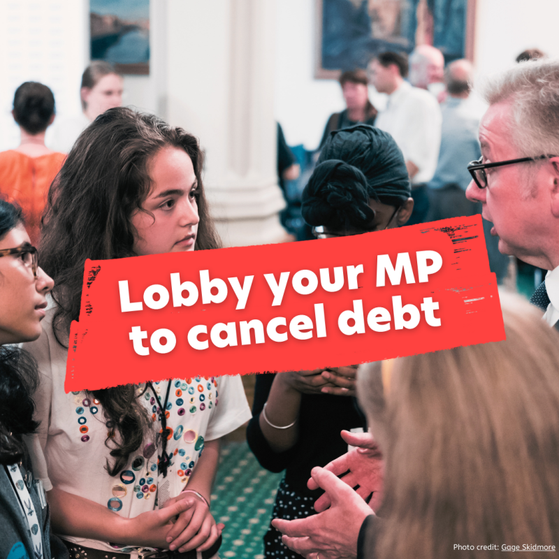 Activists meeting Michael Gove at the last mass MP Lobby. Text reads: lobby your MP to cancel debt